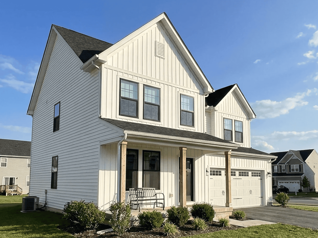 Modern White House with Garage White house with black roof and attached garage, featuring large windows and a front porch, in a sub.