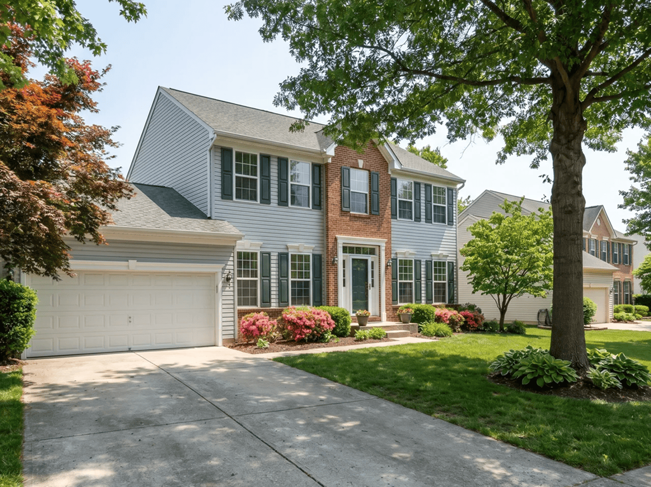Home Exterior Renovation Beautiful two-story suburban house with fresh siding and landscaping.